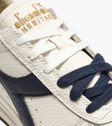 B. ELITE Dominio | White/Peacoat | DIADORA
